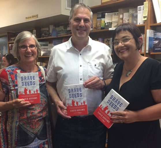 David Abrams (center) with Barbara Theroux and Mara Panich-Crouch of Fact & Fiction at the "Brave Deeds" launch. 