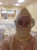 Store owner, Sylla McClellan, suited up to paint the new space