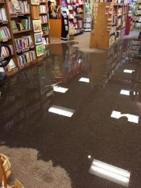 Store lights reflected on the water on the shop floor.