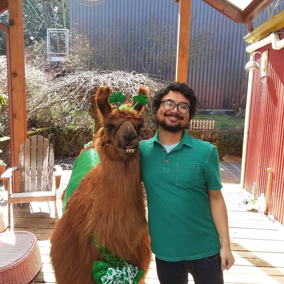 Therapy llama and Earl Dizon on the deck at Green Bean Books