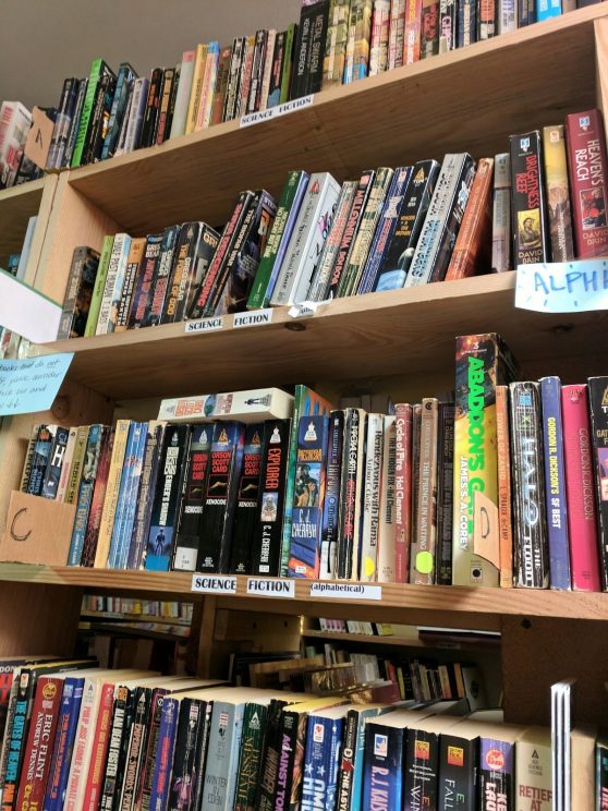 Shelves of books to mail at Books to Prisoners