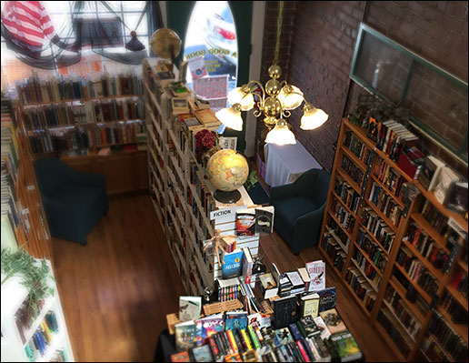 photo from above of the interior of A Good Book Bookstore in Sumner, WA, with bookshelves and a globe. 