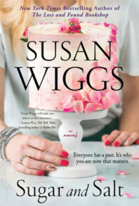 Cover of "Sugar and Salt" by Susan Wiggs (showing a woman's torso and hands with a pink cake on a white cake stand.)