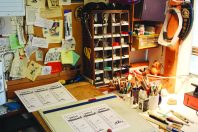 Sam Goto's desk and shelving, filled with works in progress, sketches, and other nifty little things